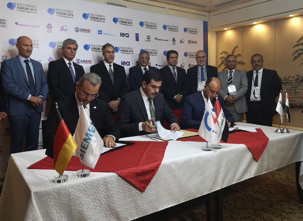 From (L to R) Karim Amin, CEO of Siemens Power Generation, Waleed Khaled Hassan, director general, general state company for electricity production north region and Orascom CEO Osama Bishai, sign a contract in the Iraqi capital Baghdad