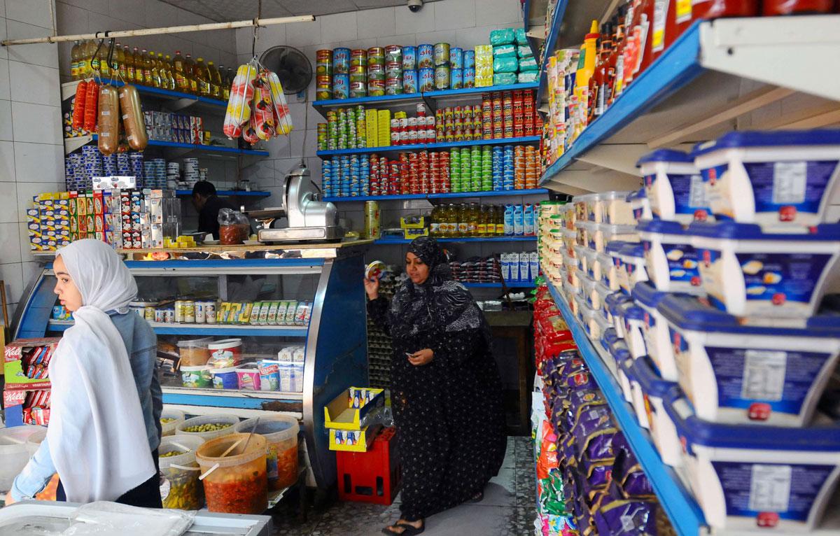 People shop inside a market in Giza, Egypt