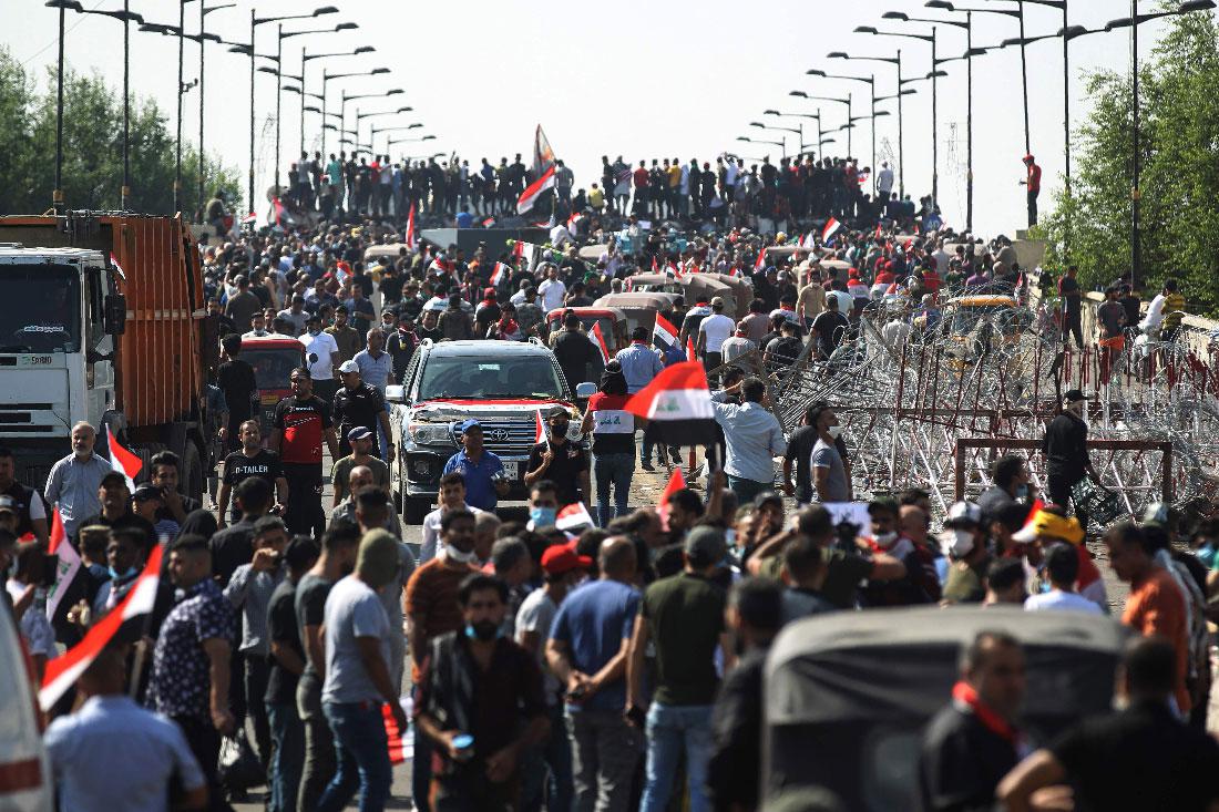 Iraqi protesters gather on the capital Baghdad's Al-Jumhuriyah Bridge