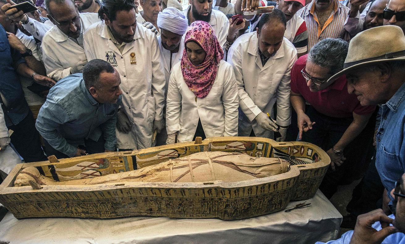 Egyptian officials and archaeologists surround a sarcophagus belonging to a man in front Hatshepsut Temple at Valley of the Kings in Luxor