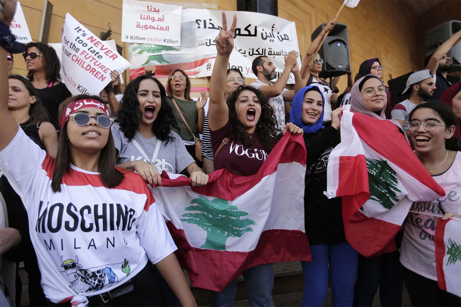 Anti-government protesters shout slogans against the Lebanese government in Beirut