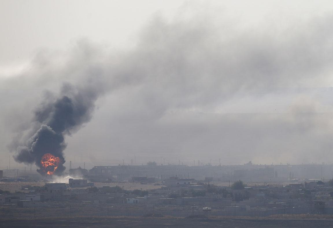 An explosion is seen over the Syrian town of Ras al-Ain as seen from the Turkish border town of Ceylanpinar