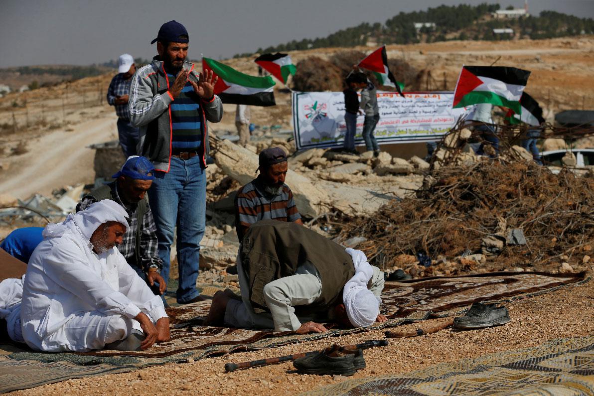 Palestinians attend Friday prayer during a protest against Jewish settlements near Yata, in the Israeli-occupied West Bank