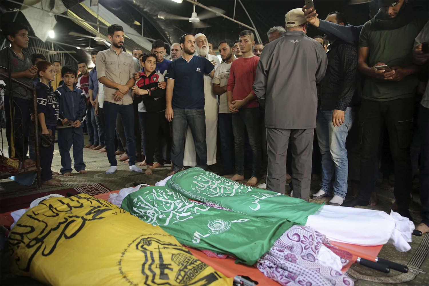Mourners prepare for prayers over the bodies of Rafat Ayyad and his two sons, who were killed in an Israeli airstrike in Gaza City