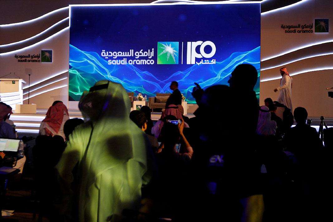 A sign of Saudi Aramco's initial public offering is seen before the start of a news conference by the state oil company at the Plaza Conference Center in Dhahran