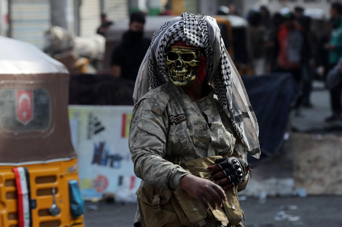 An Iraqi demonstrator wears a mask during ongoing anti-government protests in Baghdad