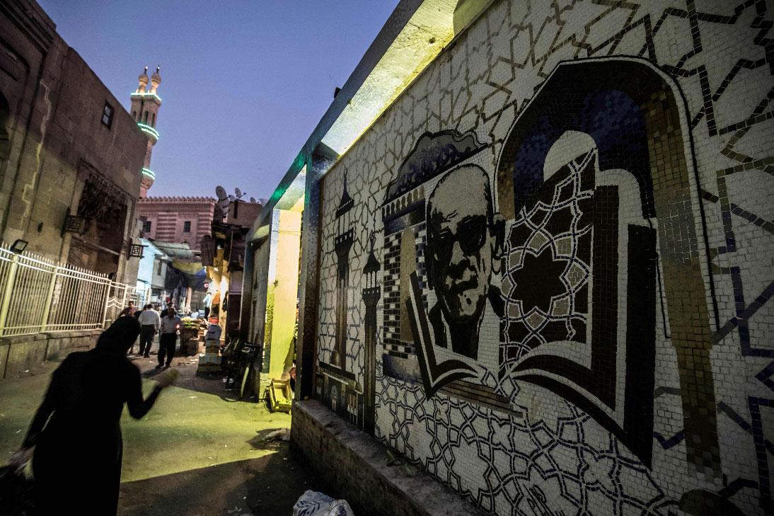 A mural depicting Egyptian novelist and nobel prize winner Naguib Mahfouz is pictured behind the al-Azhar mosque in downtown Cairo 