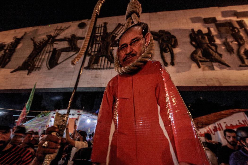 A bust of Former Iraqi Prime Minister Nuri al-Maliki is placed near a symbolic gallows