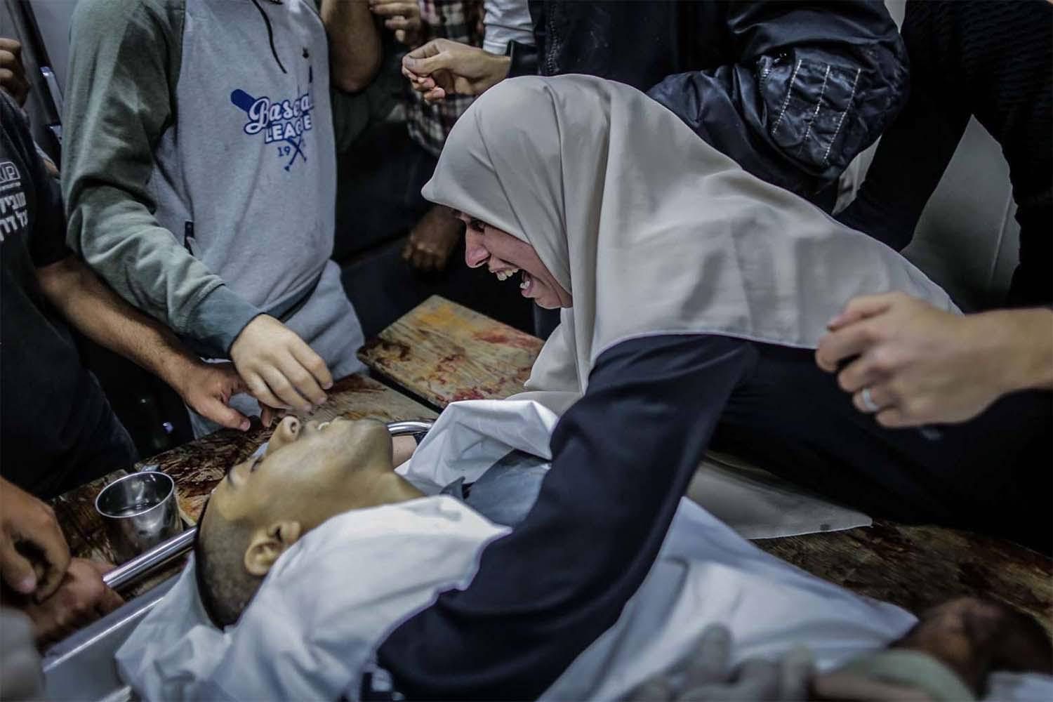 A woman mourns over the body of Zaki Ghanama, 25, in morgue at Beit Lahia northern the Gaza strip
