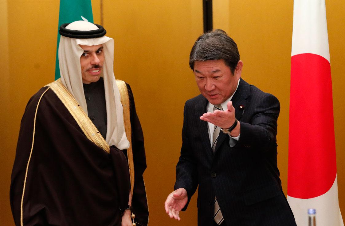 Japanese Foreign Minister Toshimitsu Motegi shows the way to Saudi Arabia's counterpart Prince Faisal bin Farhan at a bilateral meeting during the G20 Foreign Ministers meeting in Nagoya