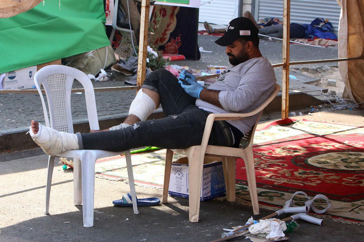 A wounded Iraqi protester resting under a tent in al-Khalani square in central Baghdad 
