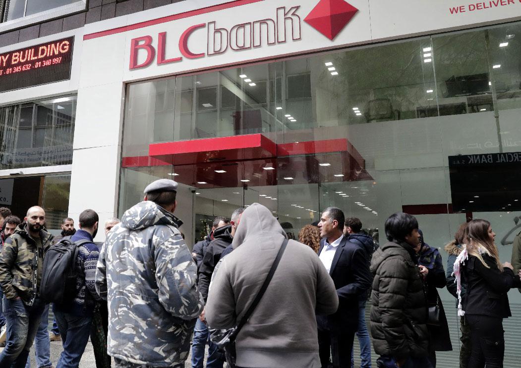 Lebanese protesters occupy a branch of BLC Bank in the capital Beirut