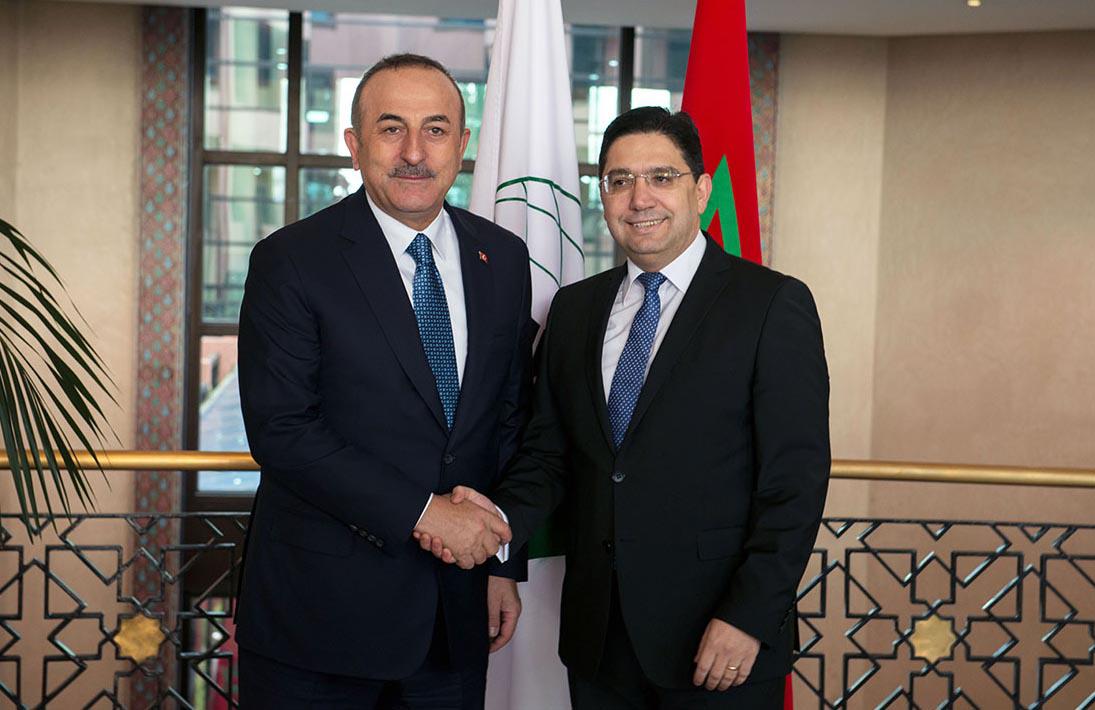 Turkish foreign minister Mevlut Cavusoglu shaking hands with Moroccan counterpart Nasser Bourita