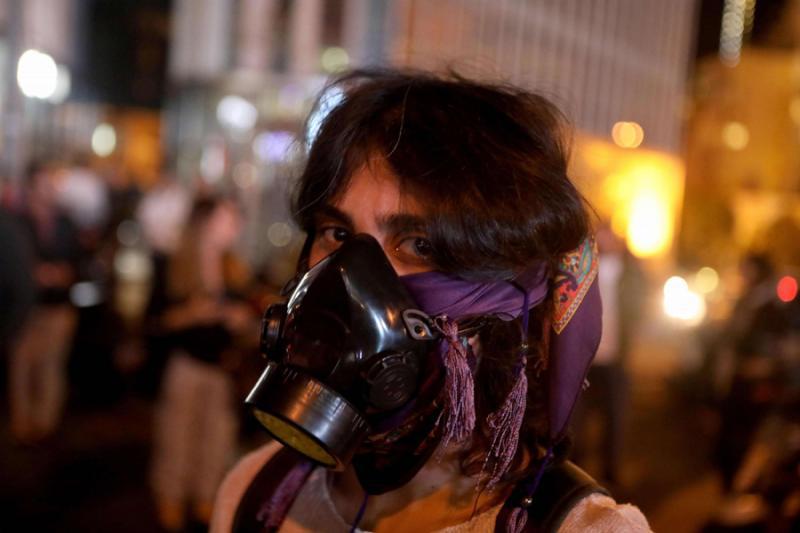 A Lebanese anti-government protester wears a gas mask in Beirut