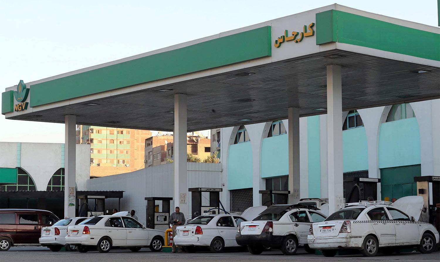 Taxis and cars are filled up with gas at Natural Gas Vehicles (NGV) petrol station in Cairo