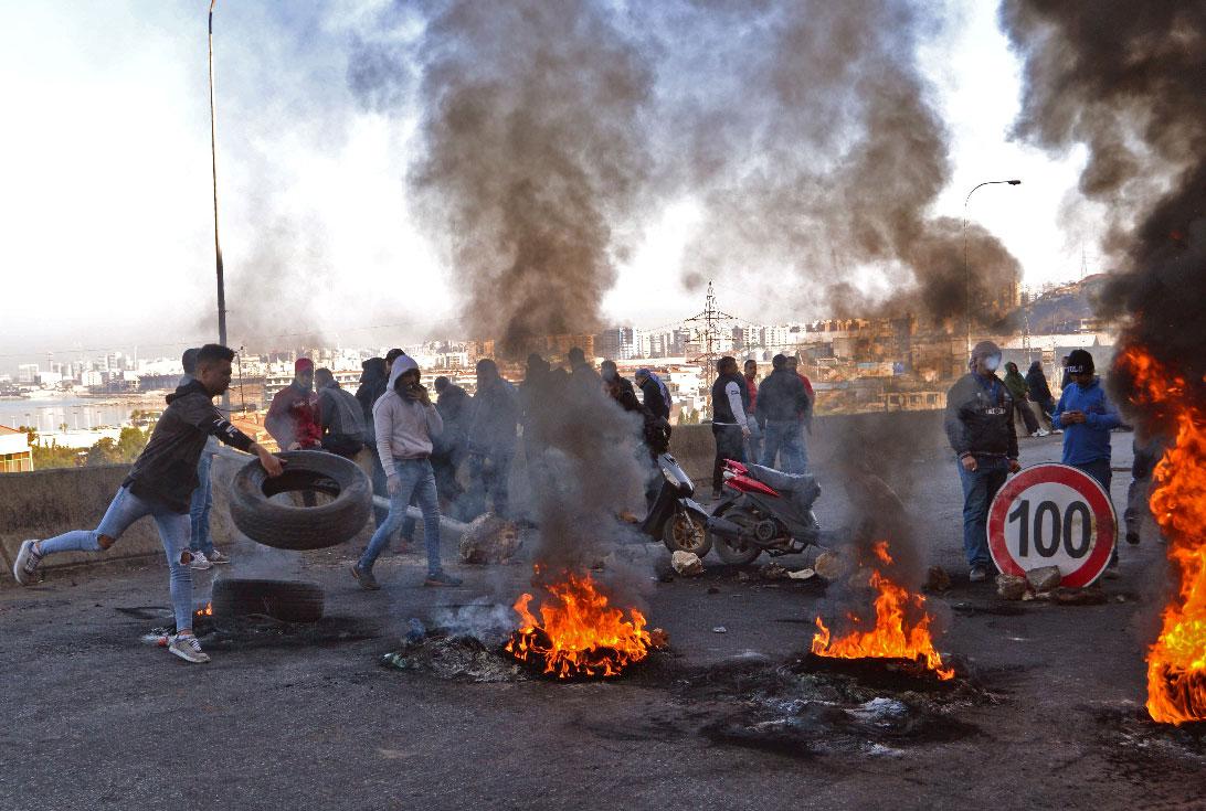 Lebanese protesters block a road in the northern city of Tripoli