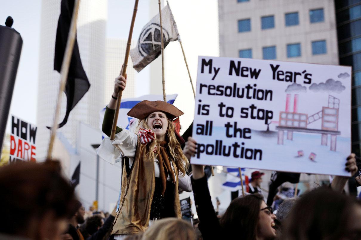 A protester holds a placard as she takes part in a demonstration against Israel's offshore Leviathan natural gas field