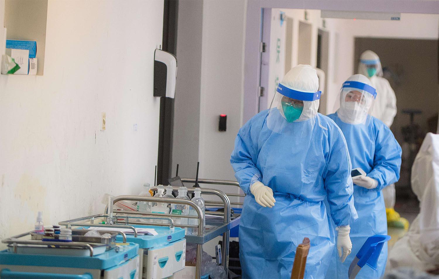 Medical personnel wearing protective suits work in the department of infectious diseases at Wuhan Union Hospital in Wuhan