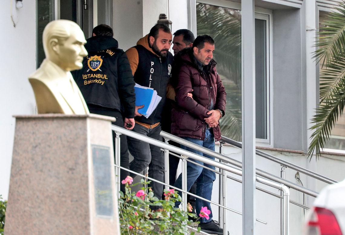 Turkish police officers escort suspects accused of involvement in Nissan's former CEO Carlos Ghosn passage through Istanbul