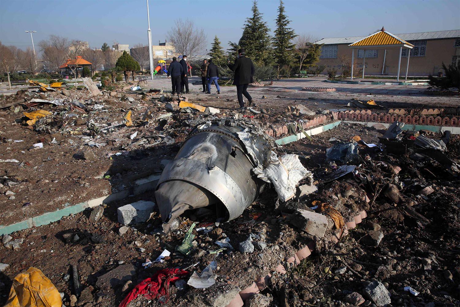 Rescue teams work amidst debris after a Ukrainian plane carrying 176 passengers crashed near Imam Khomeini airport in the Iranian capital Tehran 