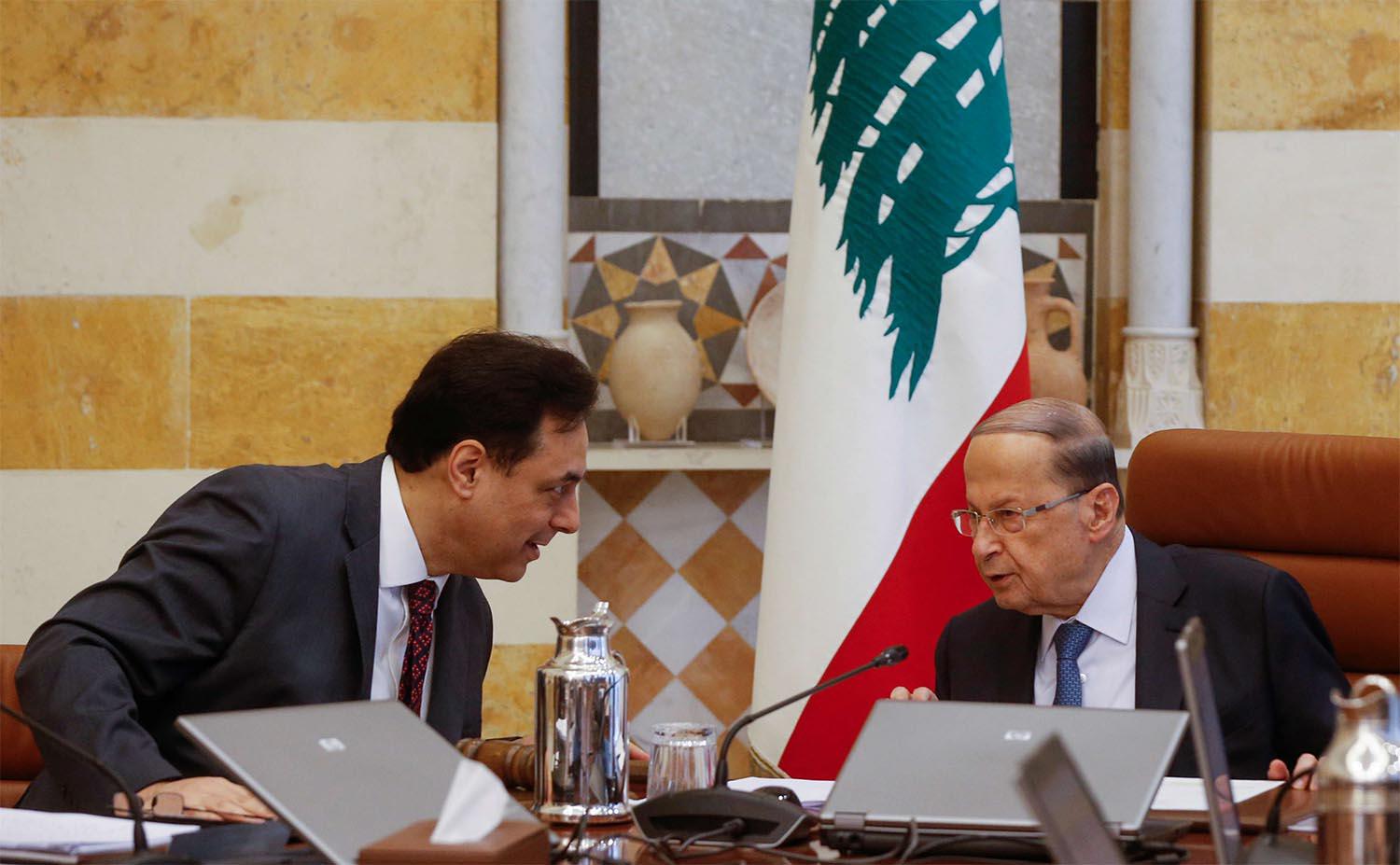Lebanon's Prime Minister Hassan Diab speaks with Lebanon's President Michel Aoun 
