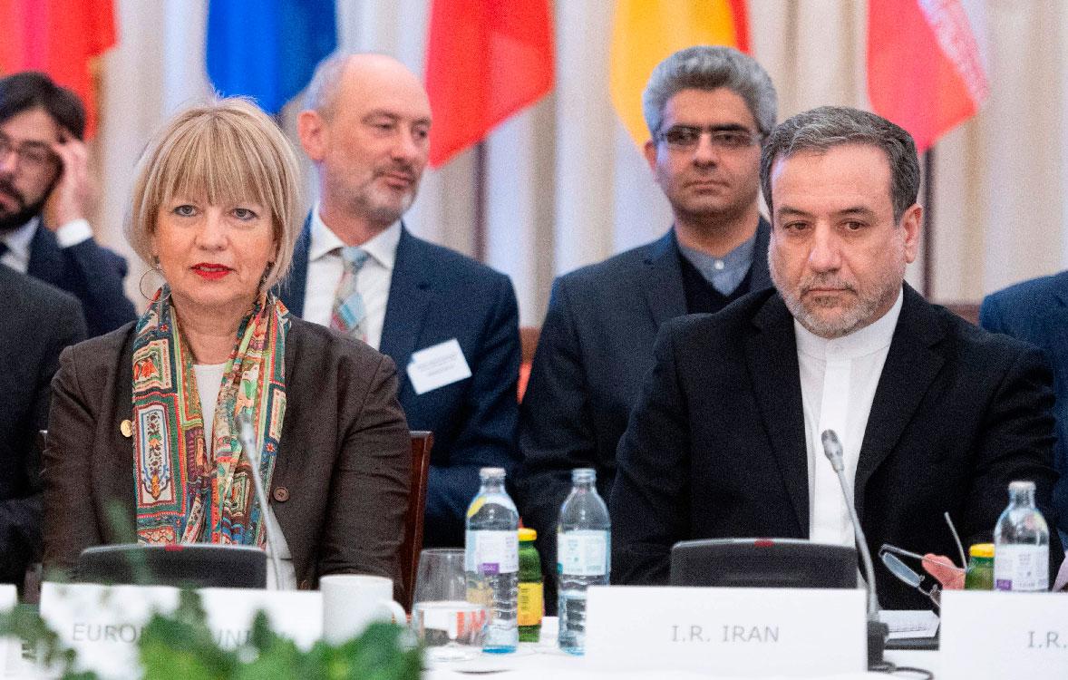 Abbas Araghchi (R), political deputy at the Ministry of Foreign Affairs of Iran, and the Secretary General of the European Union External Action Service (EEAS) Helga Schmid attend a meeting in Vienna