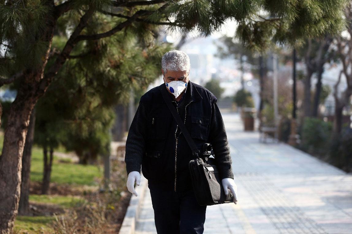An Iranian man wears a protective mask to prevent contracting coronavirus
