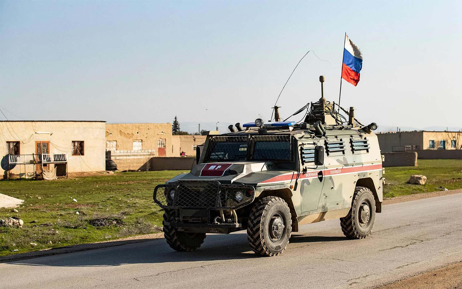 A Russian military police vehicle drives through the town of Darbasiyah in Syria's northeastern Hasakeh province