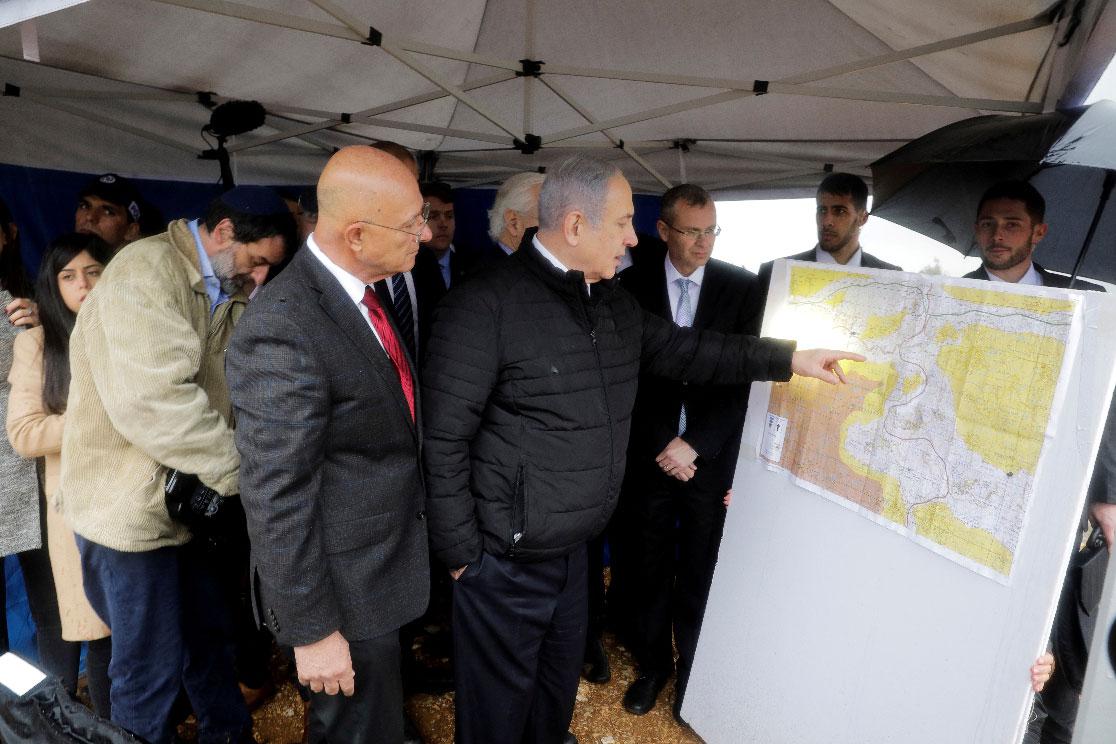 Israeli Prime Minister Benjamin Netanyahu checks the area map during his visit to Ariel settlement in the West Bank