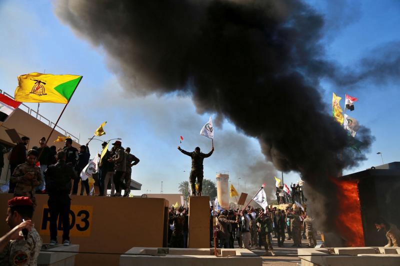 Protesters burn property in front of the US embassy compound, in Baghdad, Iraq