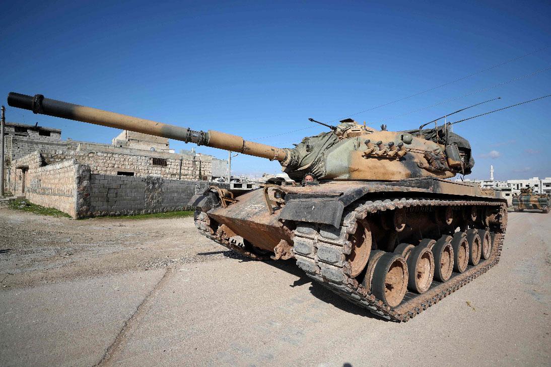 A Turkish army US-made M60 tank drives in the town of Sarmin