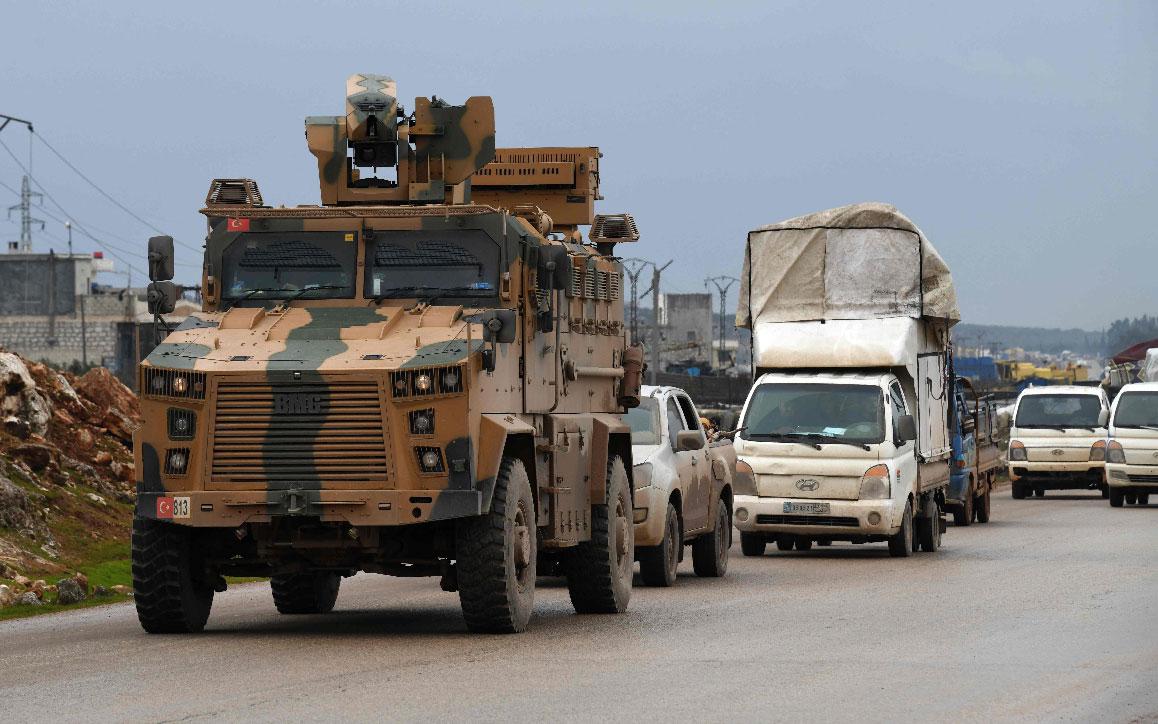 A Turkish military vehicle drives toward the Bab el Hawa border crossing in Syria