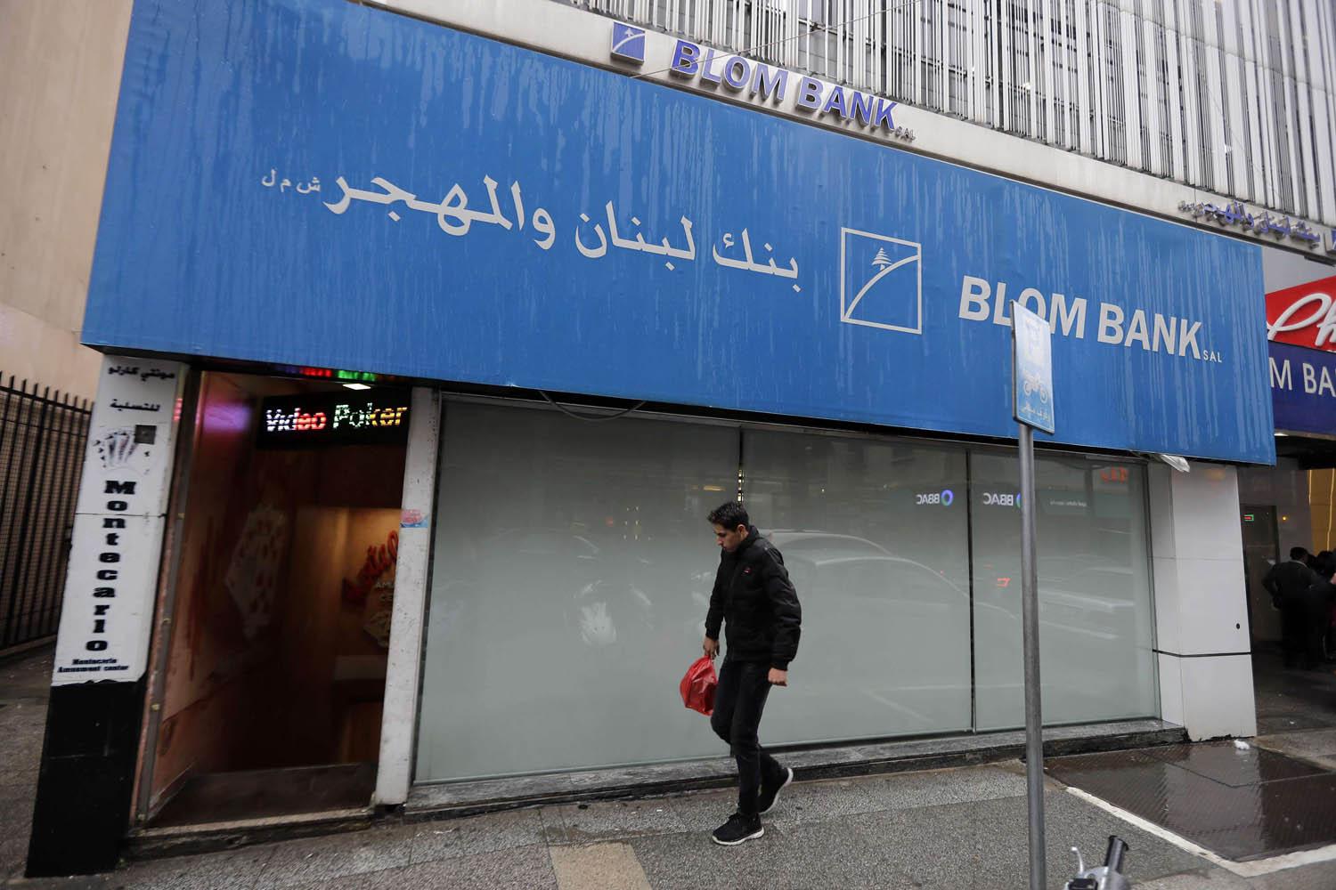 لبناني يمر بالقرب من بنك مغلق في بيروت