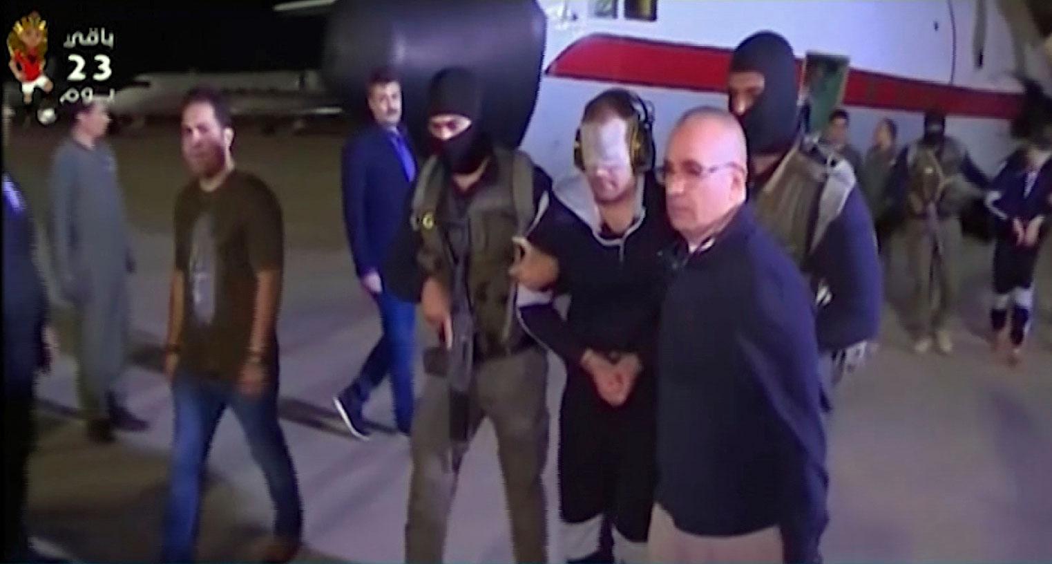 May 29, 2019 photo shows a blindfolded Hisham al-Ashmawy escorted by Egyptian military officers
