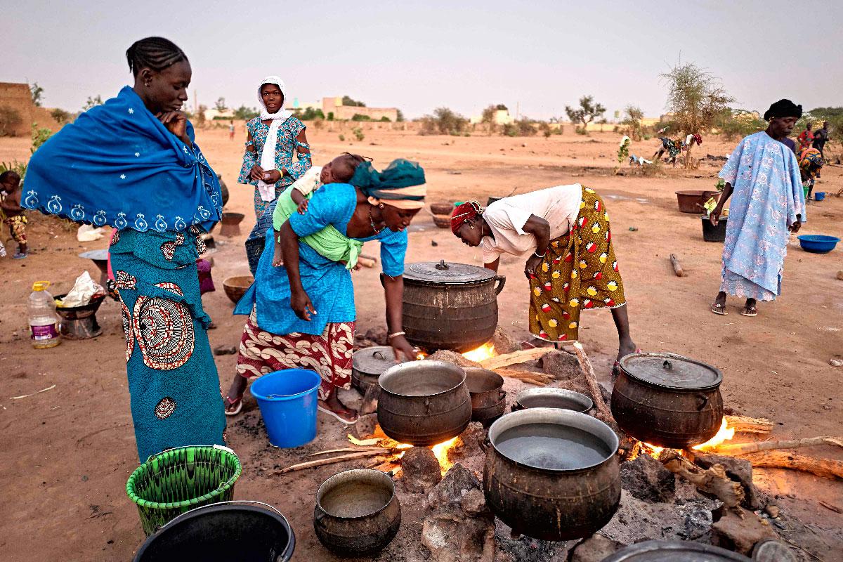 Displaced women prepare the dinner in a courtyard in Sevare in central Mali on February 26