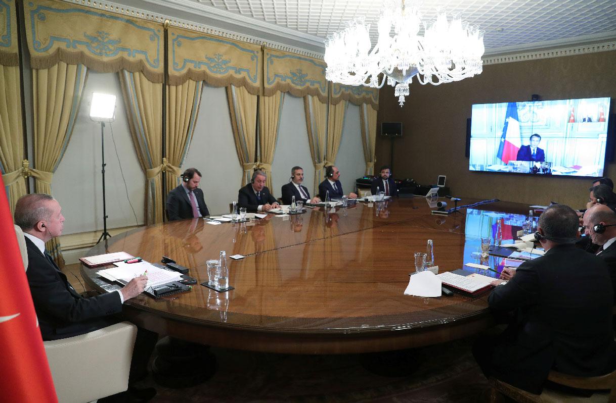 Turkish President Recep Tayyip Erdogan (L) attends a teleconference with European leaders