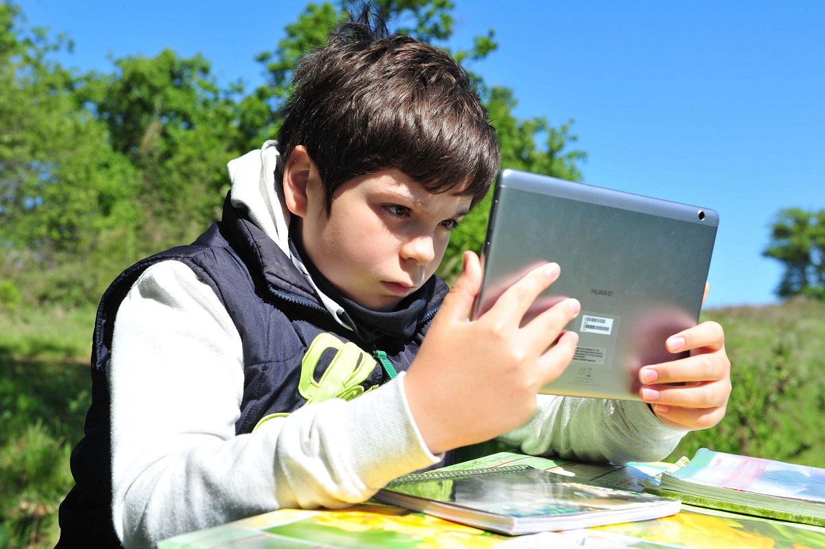 طفل يدرس عبر كمبيوتر لوحي