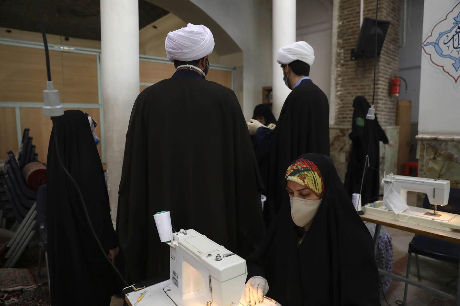 رجال دين يتفقدون معملا لخياطة الكمامات
