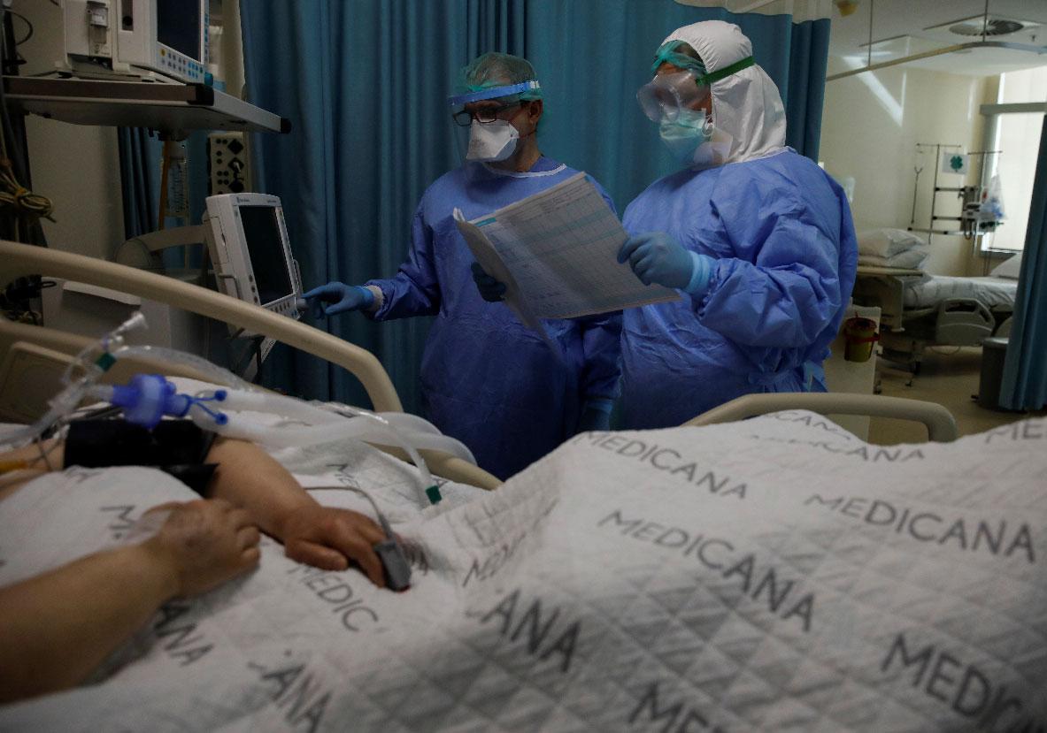 A nurse and a doctor take care of a patient suffering from the coronavirus disease (COVID-19) at an intensive care unit of the Medicana International Hospital in Istanbul, Turkey
