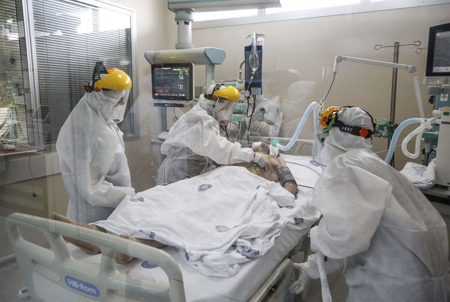 Healthcare workers tend to a patient at one of the intensive care units for COVID-19 patients (ICU) of the Akdeniz University hospital in Antalya