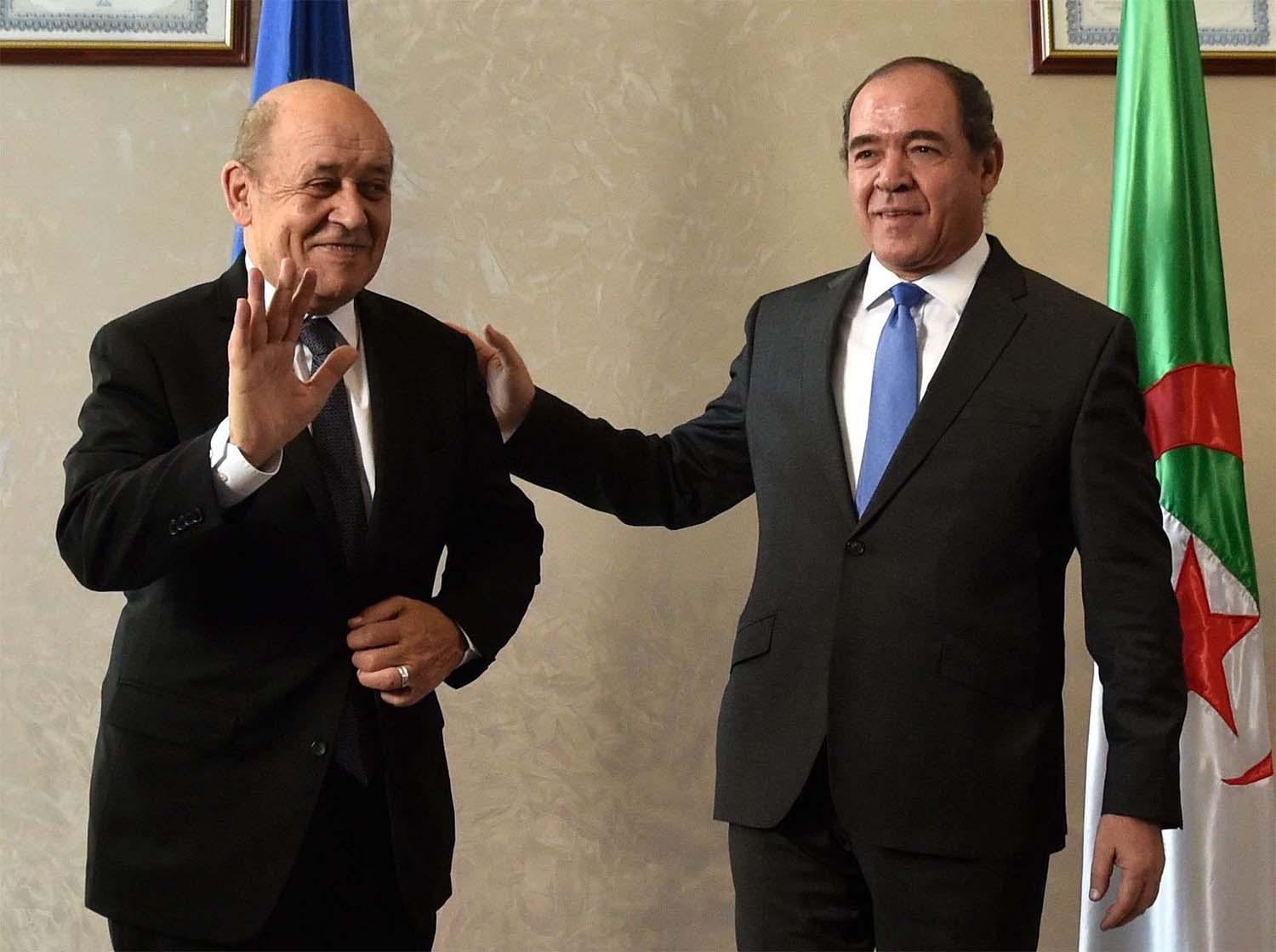 French Foreign Minister Jean-Yves Le Drian (L) and Algerian Foreign Minister Sabri Boukadoum