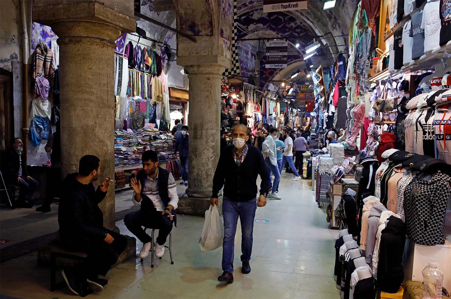 A man wearing a protective face mask walks at Grand Bazaar