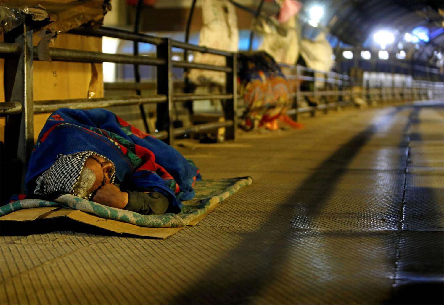 A homeless man sleeps on a pedestrian bridge in Cairo