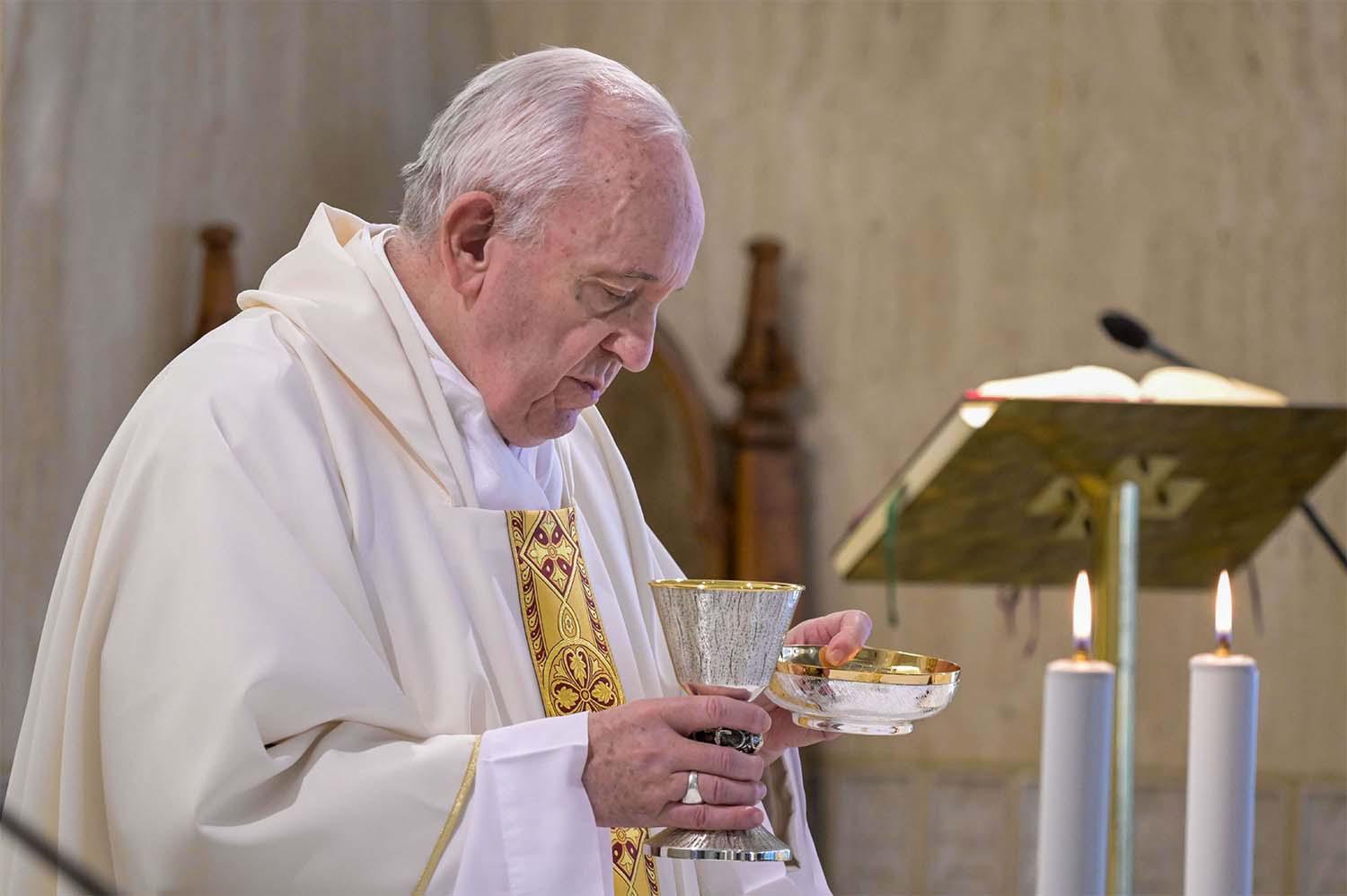 Pope Francis celebrating the Eucharist during a mass at the Santa Marta chapel in The Vatican