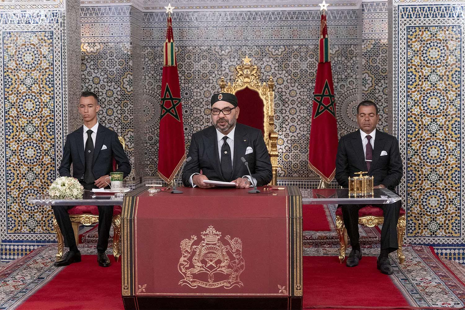 Morocco's King Mohammed VI, center, accompanied by his son Crown Prince Moulay Hassan, left, and brother Prince Moulay Rachid