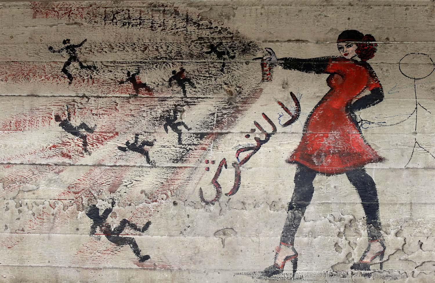 A mural with Arabic that reads "no to harassment," is seen on a wall in Cairo