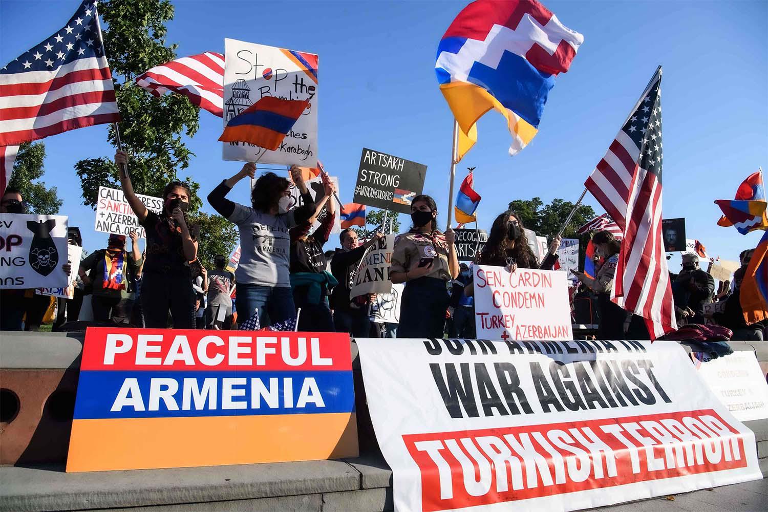 Armenian-Americans hold signs and flags as they protest against Turkey's support for Azerbaijan in front of the US Capitol in Washington