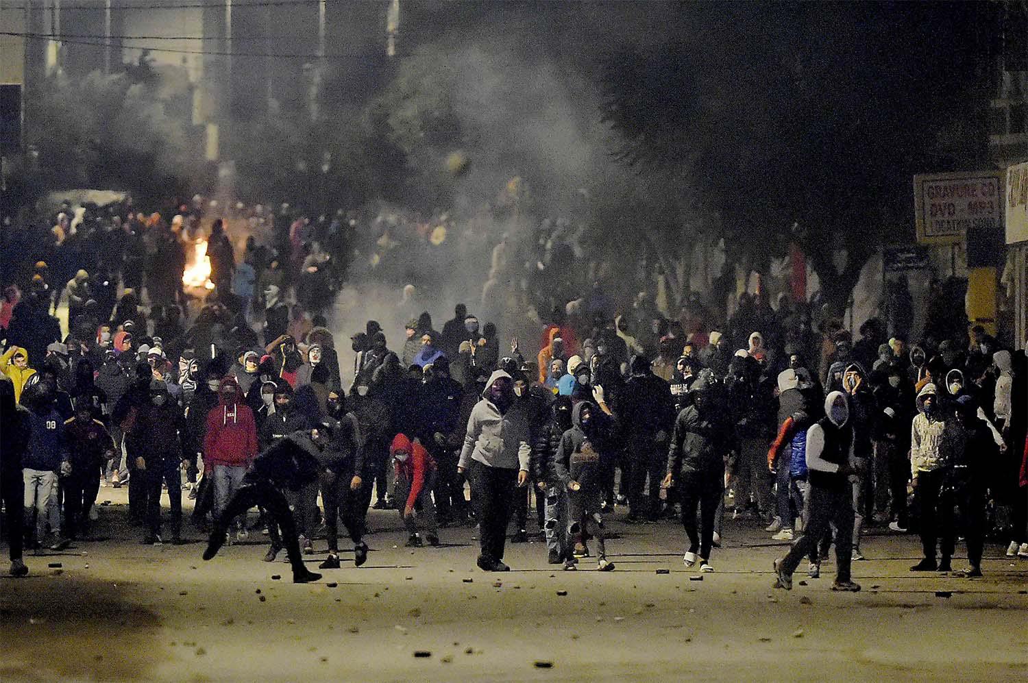 Up to 300 young men clashed with police in Tunisian capital's Ettadamon district