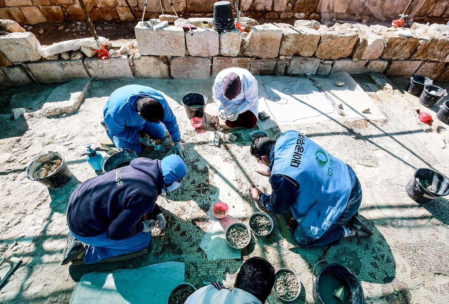 Local people and Syrian refugees work side-by-side to restore the ruins