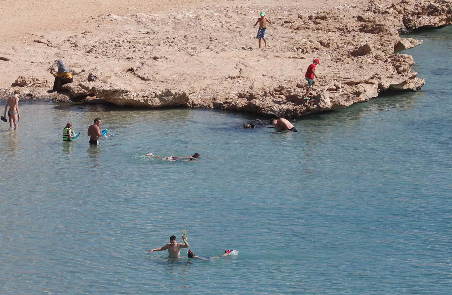 Tourists enjoy a day by the beach in the Red Sea resort of Sharm el-Sheikh.